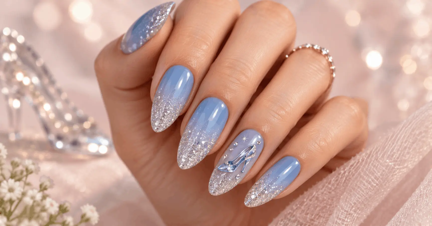 Manicured hand with blue-to-silver glitter ombré Cinderella nail design